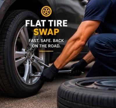 A technician kneeling at a front wheel with a lug wrench, the spare tire lying ready beside them.